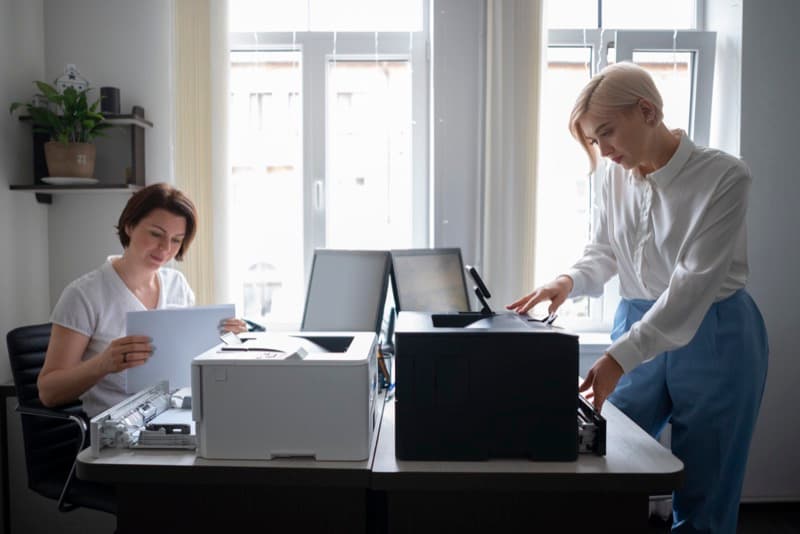 women-work-office-using-printer
