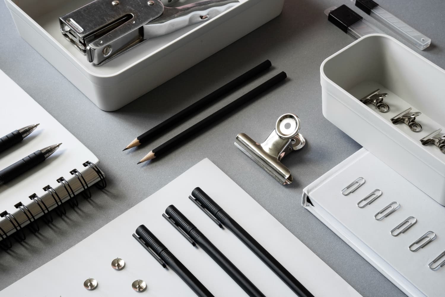 Open cupboard revealing various office essentials stored in compartments.